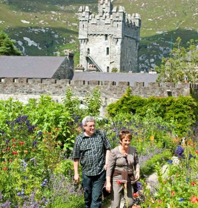 A couple walking through gardens at Glenveagh Castle